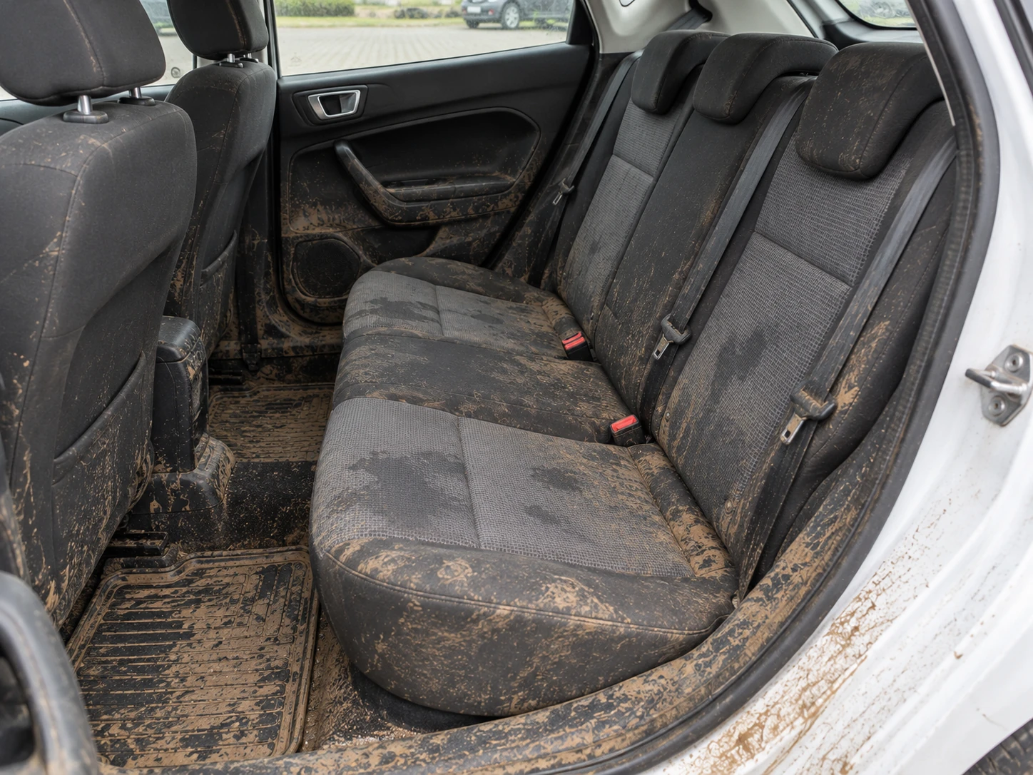 AI illustration of a muddy Ford Fiesta rear seat, door trim and flooring